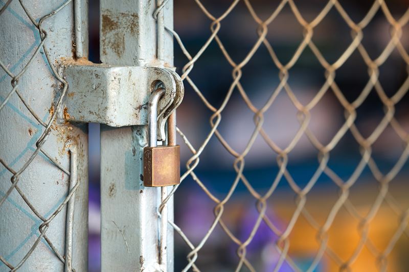A lock on a chain-link fence.